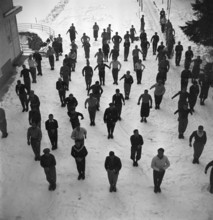 Ski instructors doing gymnastics before skiing, Davos 1940