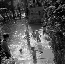 Children splashing around, adventure playground Ruschlikon 1954