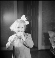 Girl eats piece of bread, approx. 1950