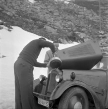 Automobilist pouring water into the cooler, Gotthard 1957