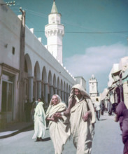 Leading blind person in street.