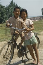 CHINA, Transport, Two children sharing an adult bicycle