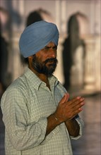 INDIA, Punjab, Amritsar, Hari Mandir or Golden Temple. Portrait of a man in prayer at the Sikh