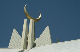 PAKISTAN, Islamabad, Faisal Mosque roof detail with golden crescent moon symbol.