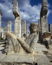 MEXICO, Yucatan, Chichen Itza, Mayan ruins with statue of reclining man and columns