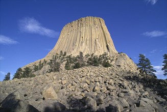 USA, Wyoming, Devils Tower, 867ft high National Monument of volcanic outcrop with bolders leading
