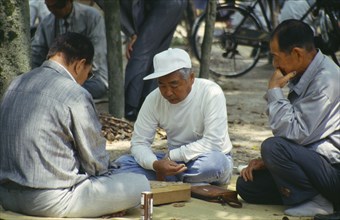 JAPAN, Honshu, Hiroshima, Men playing game on a mat in the Peace Park