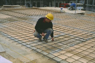 ARCHITECTURE, Construction, Workman laying reinforcing steel for flooring