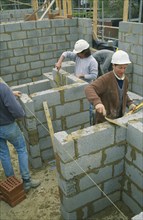 ARCHITECTURE, Construction, Workmen laying concrete blocks
