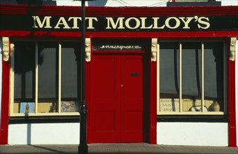 IRELAND, County Mayo, Westport, Matt Malloys traditional Pub front with bright red door