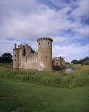 SCOTLAND, Dumfries and Galloway, Caerlaverock Castle ruins with surrounding moat