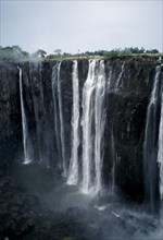 ZIMBABWE, Waterfall, Zambezi River Victoria Falls. Waterfall plummeting 355 feet over a sheer cliff