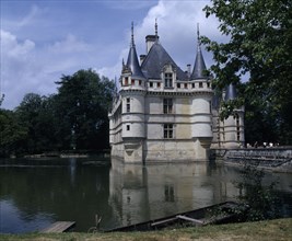 FRANCE, Loire Valley, Azay Le Rideau Chateau and Water filled Moat Bridge Boat Moared On Bank In