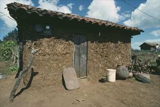 MEXICO, Paraje , Exterior of a Chamula Indians house with mud walls and tiled roof