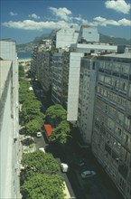 BRAZIL, Rio de Janeiro, "Aerial view along city street toward Ipanema and favela, or slum, on a