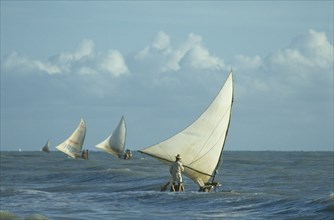 BRAZIL, Ceara, Near Fortaleza, Jangodas going fishing in the early morning choppy seas