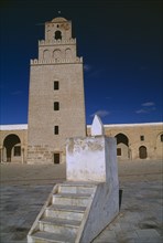 TUNISIA, Kairouan, Mosque and courtyard with minaret behind and lecturn in the foreground