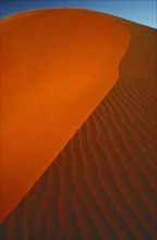 LIBYA, Sahara Desert, Archan, Slip face edge of red sand dune in the south west
