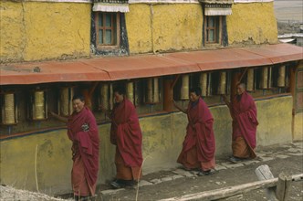 CHINA, Sichuan, Zoige, Monks turning prayer wheels at Zoige monastery