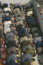 CHINA, Gansu Province, Lanzhou, View looking down on rows of muslims at prayer.