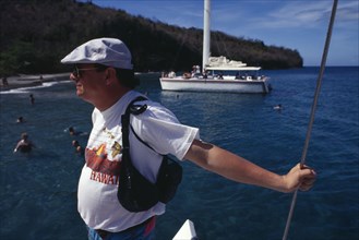 WEST INDIES, St Lucia, Tourists, Tourist taking catamaran tour.