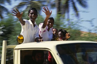 SRI LANKA, People, Children, Children waving from the back of a truck driven by man.