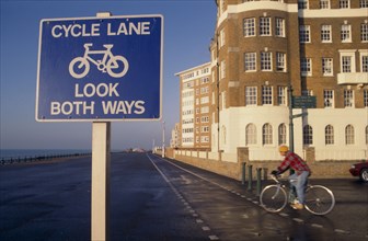 10012731 SPORT  Cycling Cyclist on cycle lane on Hove seafront with sign in the foreground