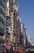JAPAN, Honshu, Tokyo, Advertising down the side of buildings in the Shinjuku district with the