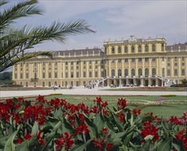AUSTRIA, Lower Austria, Vienna, Schonbrunn Palace and formal gardens with a bed of red flowers in