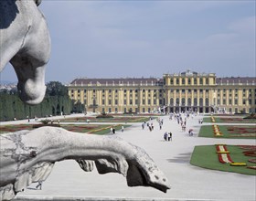 AUSTRIA, Lowe Austria, Vienna, Schonbrunn Palace and tourists walking in the formal gardens with a