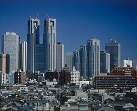 JAPAN, Honshu, Tokyo, Shinjuku high-rise skyscrapers seen beyond the rooftops of the city