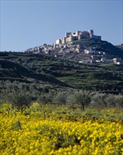 SYRIA, Central, Crac des Chevaliers, "The Crusader Castle on hilltop, village surrounds, yellow