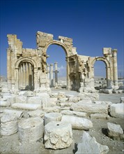 SYRIA, Central, Tadmur, "Palmyra monumental Arch remains, three arches,pillars behind,broken stone.