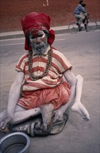 NEPAL, Kathmandu, Crippled Sadhu / Holy Man begging