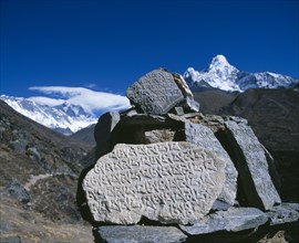 NEPAL, Sagarmatha National Park, Mount Everest, Mani stones in foreground with snow capped peak of