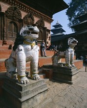 NEPAL, Kathmandu , Durbar Square.  Two lion statues at entrance to temple.