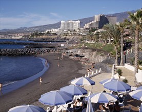 SPAIN, Canary Islands, Tenerife, Playa de la Americas with black sandy beach and apartments in the