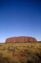 AUSTRALIA, Northern Territories, Ulhuru, Ayres Rock in desert landscape.