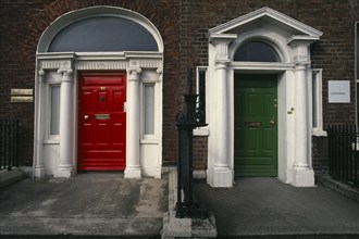 Ireland, Dublin, "Two Georgian front doors, one red and one green, separated by railings. Both with