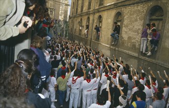SPAIN, Navarra, Pamplona , San Fermin Bull Run Festival prayers in a narrow street  before bull run