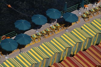ITALY, Campania, Sorrento, "View over green and yellow and red and yellow striped beach huts, green