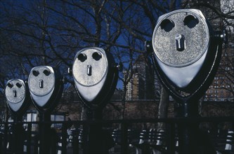 USA, New York, Battery Park, Line of pay binoculars that look like faces