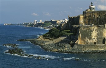WEST INDIES, Puerto Rico, San Juan, View along San Juan coastline with fort and old city walls.