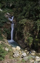 PHILIPPINES, Luzon, Near Baguio, "Waterfall,greenery on rocks,boulders in stream "