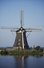 HOLLAND, Zuid Holland, Kinderdijk, Windmill on the riverbank of the Rhine.