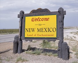 USA, New Mexico, General, Welcome To New Mexico sign in yellow with a wooden surround beside the