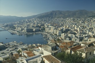 GREECE, Macedonia, Kavala, View over town buildings towards distant mountains.