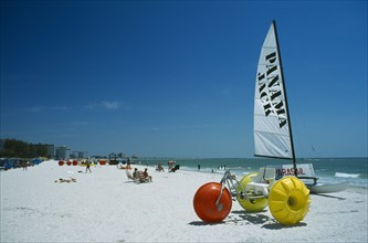 USA, Florida  , St.Petersburg, Hobbie cat and pedalo on stretch of white sand beach with few