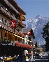 SWITZERLAND, Bern Oberland, Grindelwald, Main street and hotel e distancewith flags on the