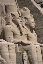 EGYPT, Abu Simbel, Two of the giant statues of Ramesses II at the entrance to the Great Temple
